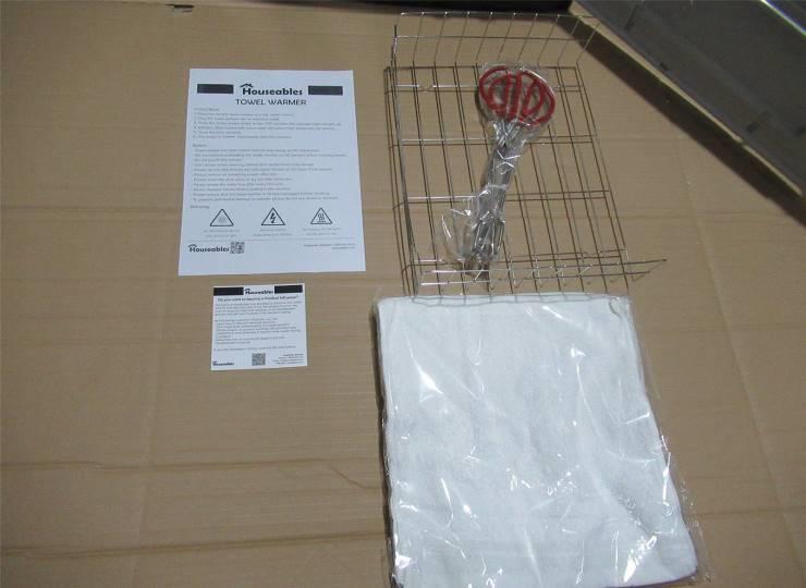 Appliance accessories and documents laid out for checking